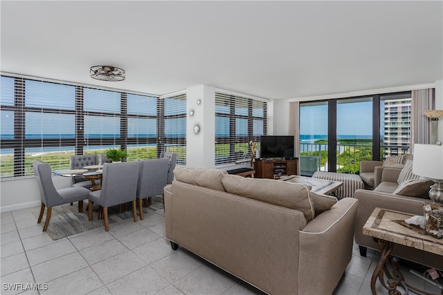 living room featuring floor to ceiling windows and light tile patterned floors