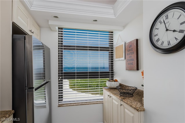 interior space with ornamental molding, white cabinets, and stone countertops