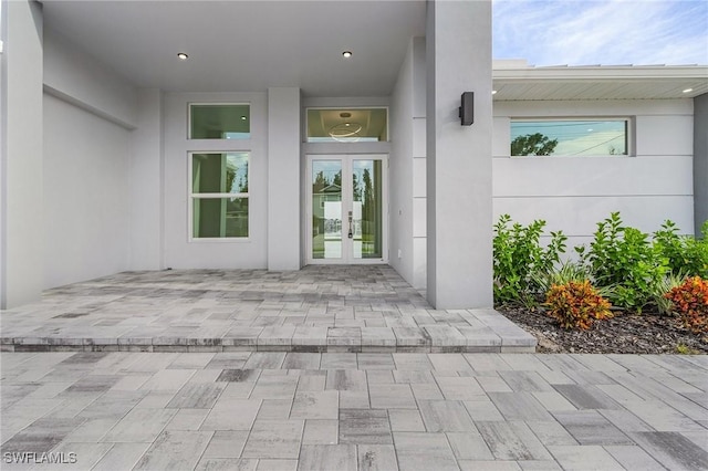 doorway to property with french doors and stucco siding