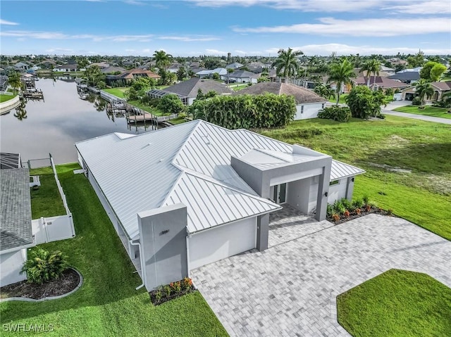 drone / aerial view with a residential view and a water view