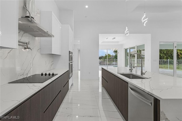 kitchen featuring marble finish floor, modern cabinets, white cabinetry, appliances with stainless steel finishes, and wall chimney range hood