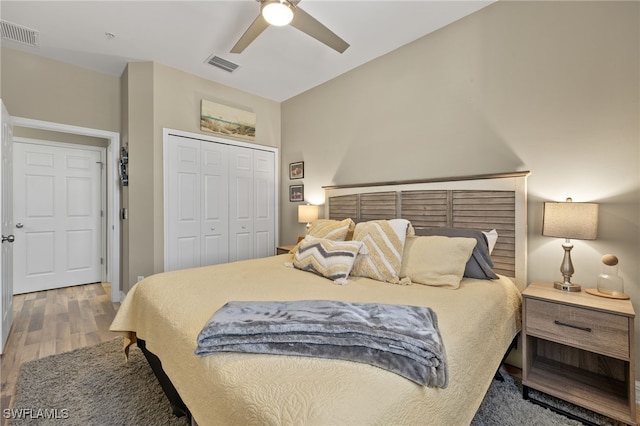 bedroom with ceiling fan, a closet, and hardwood / wood-style flooring