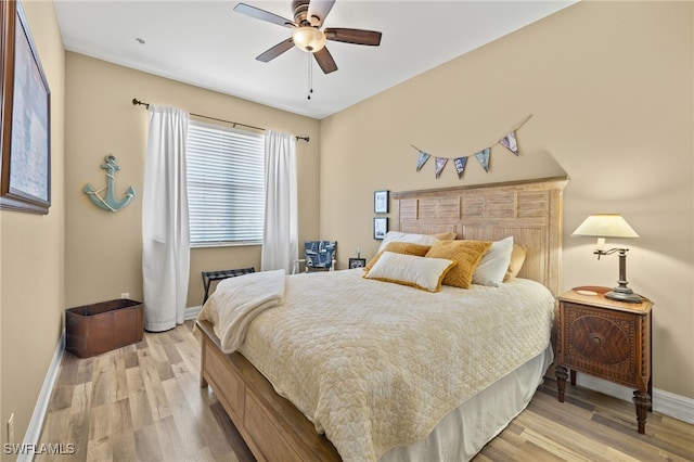 bedroom with ceiling fan and light hardwood / wood-style flooring