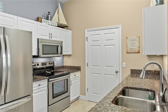 kitchen with white cabinets, light tile patterned floors, sink, and appliances with stainless steel finishes