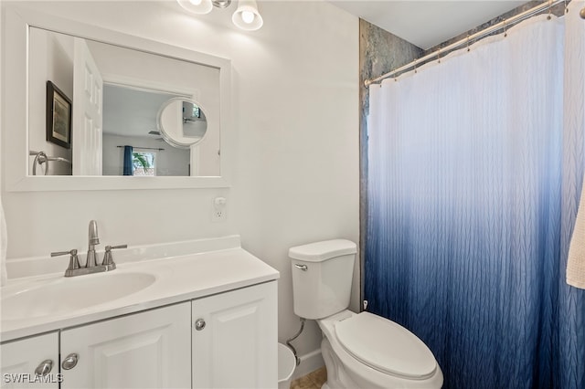 bathroom featuring vanity, toilet, and a shower with curtain