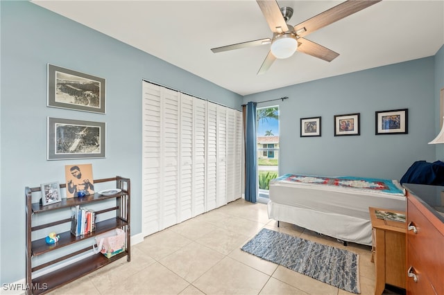 bedroom with ceiling fan, a closet, and light tile patterned floors