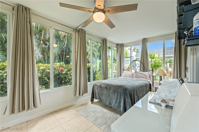 tiled bedroom featuring ceiling fan