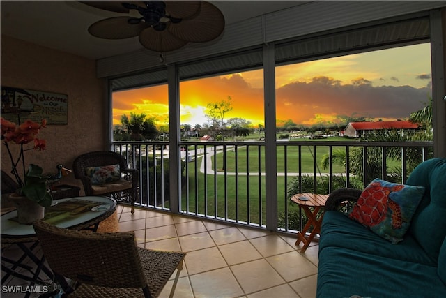 sunroom / solarium featuring ceiling fan and a wealth of natural light