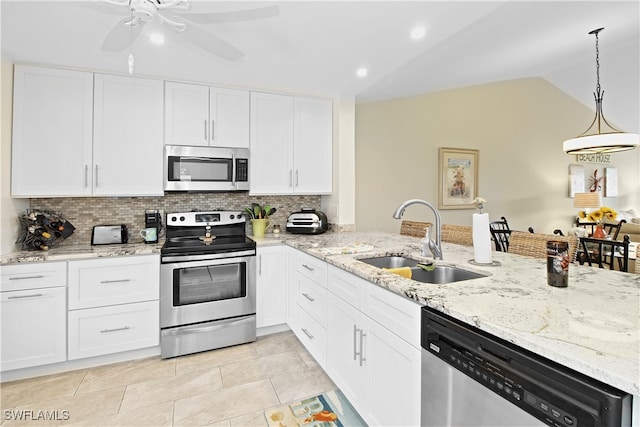 kitchen featuring sink, lofted ceiling, white cabinetry, stainless steel appliances, and ceiling fan