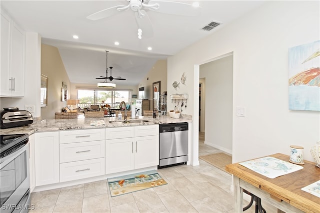 kitchen featuring appliances with stainless steel finishes, vaulted ceiling, white cabinetry, ceiling fan, and sink