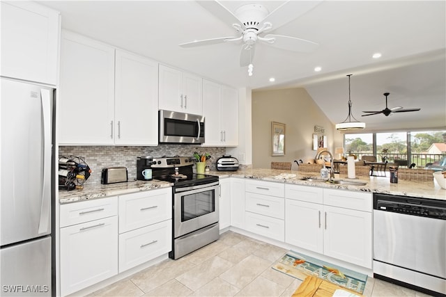 kitchen featuring sink, vaulted ceiling, white cabinetry, stainless steel appliances, and ceiling fan