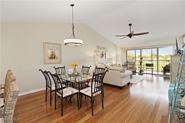 dining space featuring wood-type flooring, lofted ceiling, and ceiling fan