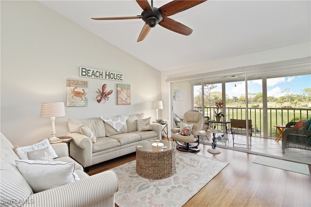 living room with wood-type flooring, vaulted ceiling, and ceiling fan