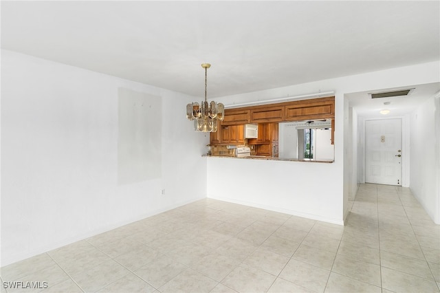 unfurnished living room with light tile patterned floors and a chandelier