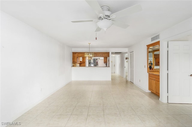 unfurnished living room with ceiling fan with notable chandelier and light tile patterned floors