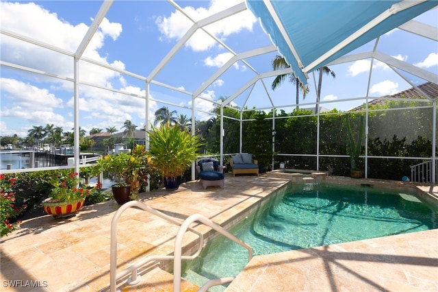 view of swimming pool featuring glass enclosure and a patio area