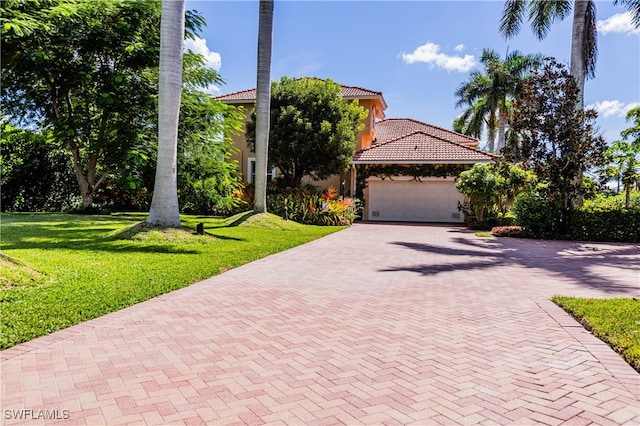 view of front of home featuring a garage and a front lawn