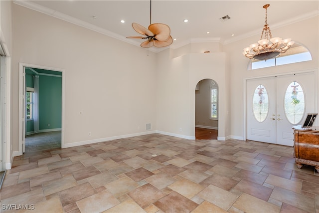 entryway featuring a wealth of natural light, french doors, a high ceiling, and ornamental molding