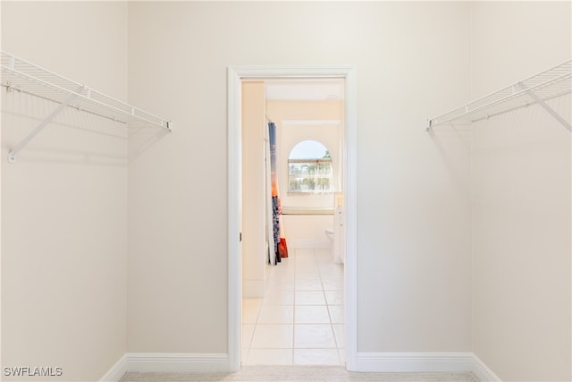 spacious closet featuring light tile patterned flooring