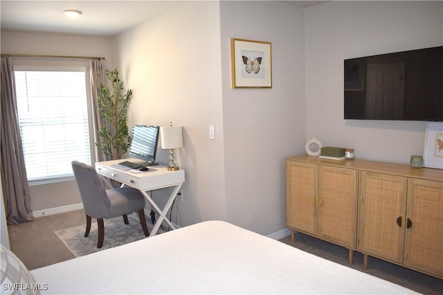 carpeted bedroom featuring baseboards
