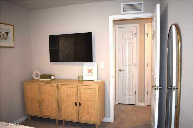bedroom featuring baseboards, visible vents, and light carpet