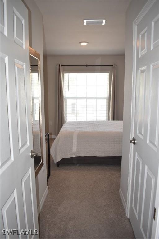 carpeted bedroom with baseboards and visible vents