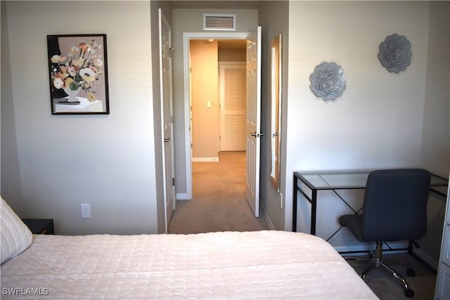 carpeted bedroom featuring baseboards and visible vents