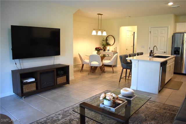 living room with light tile patterned floors and sink