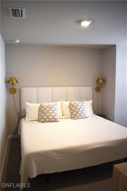 bedroom with visible vents and baseboards