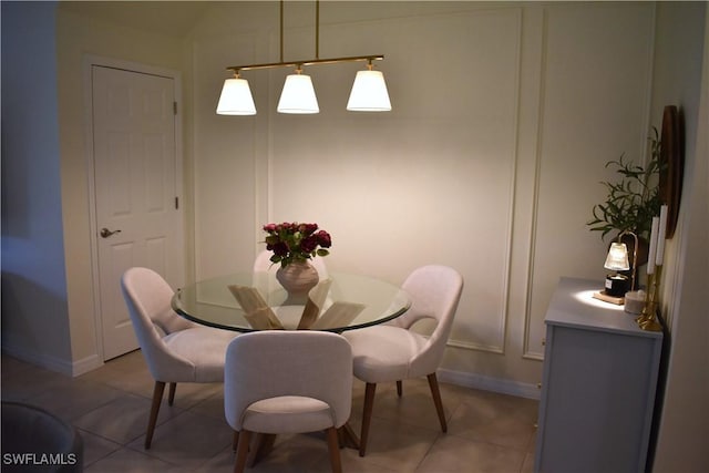 dining area with baseboards and light tile patterned floors