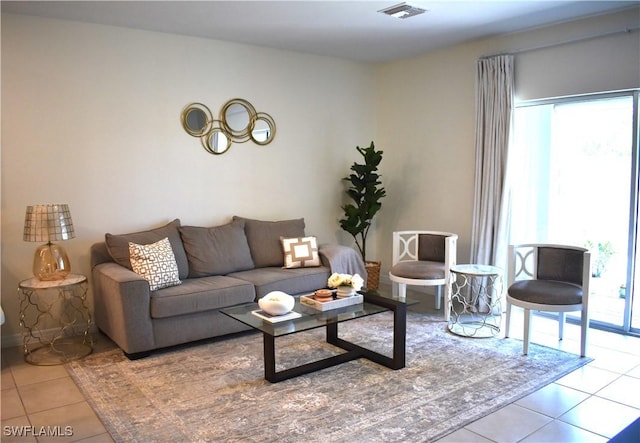 living area featuring tile patterned floors and visible vents