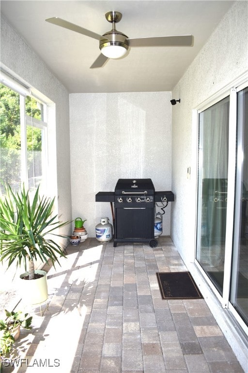 interior space featuring ceiling fan and a grill