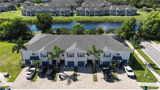 drone / aerial view featuring a residential view and a water view