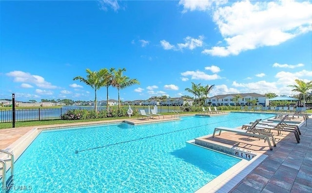 community pool featuring a patio and fence