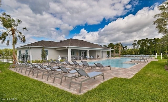 view of pool featuring a lawn and a patio area