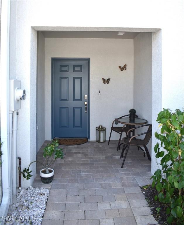 entrance to property featuring stucco siding