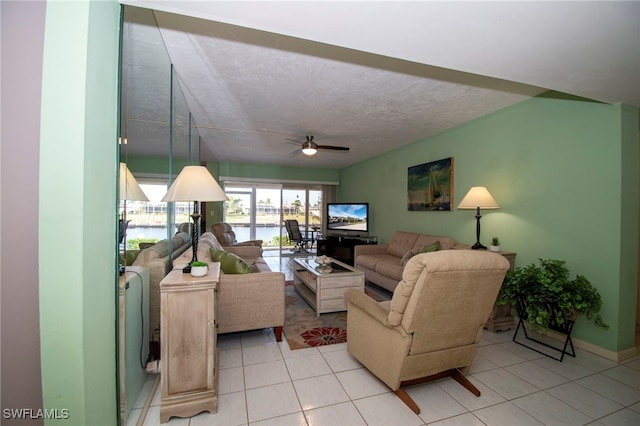 tiled living room featuring a textured ceiling and ceiling fan