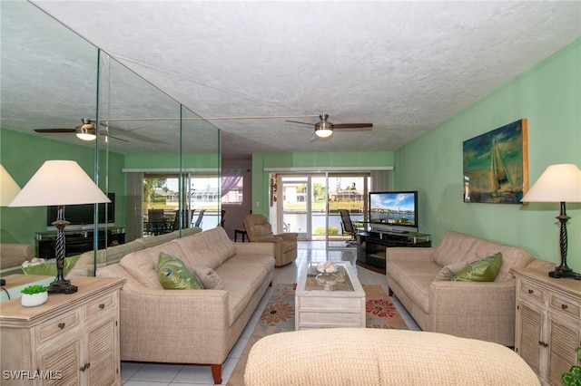 living room with light tile patterned floors, a textured ceiling, and ceiling fan