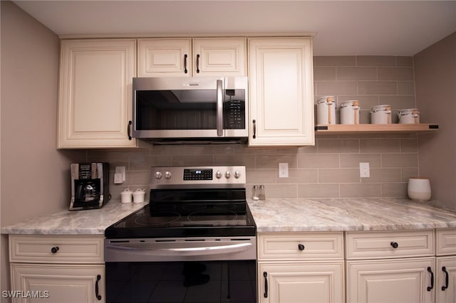 kitchen featuring appliances with stainless steel finishes, backsplash, and white cabinets