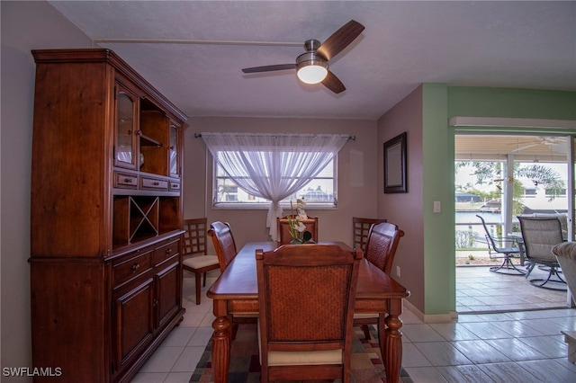 tiled dining area featuring a healthy amount of sunlight and ceiling fan