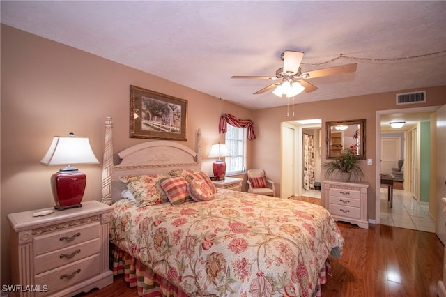 bedroom with ceiling fan and hardwood / wood-style floors