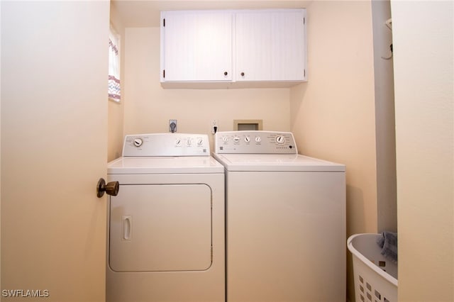 washroom featuring cabinets and independent washer and dryer