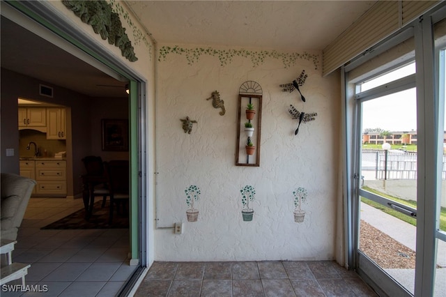 unfurnished sunroom featuring sink