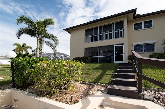 rear view of property with a yard