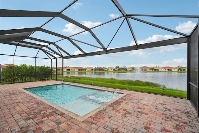 view of pool with a lanai, a water view, and a patio