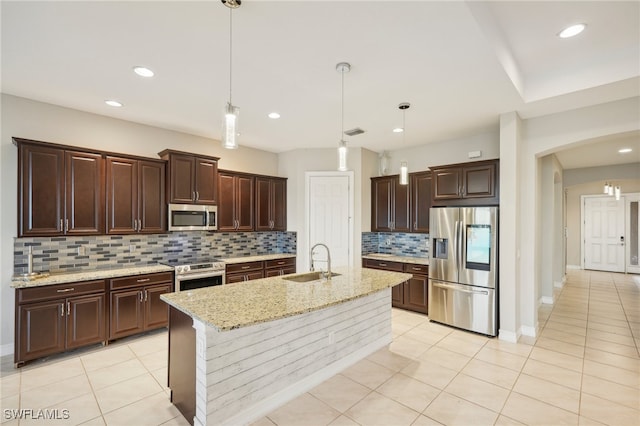 kitchen featuring a center island with sink, decorative light fixtures, appliances with stainless steel finishes, and sink