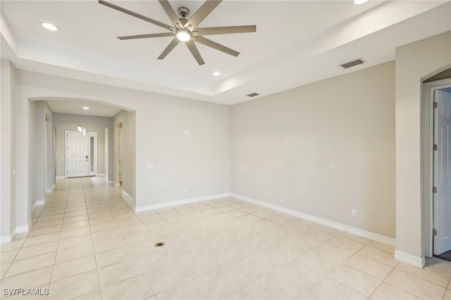 tiled spare room with ceiling fan