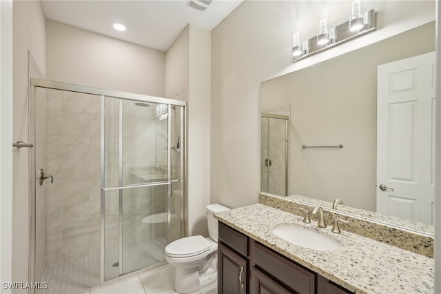 bathroom featuring tile patterned flooring, walk in shower, vanity, and toilet