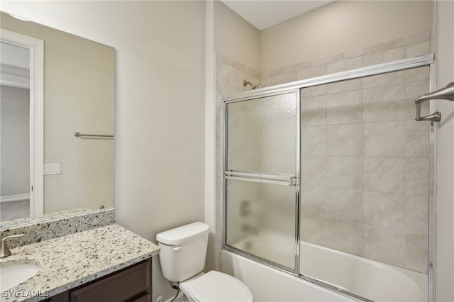 full bathroom with shower / bath combination with glass door, vanity, and toilet