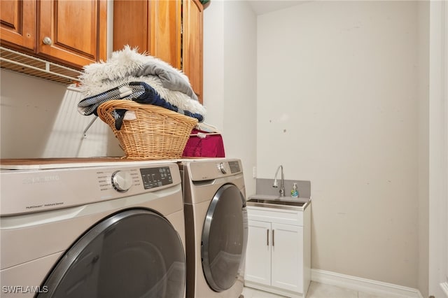 washroom with separate washer and dryer, cabinets, and sink